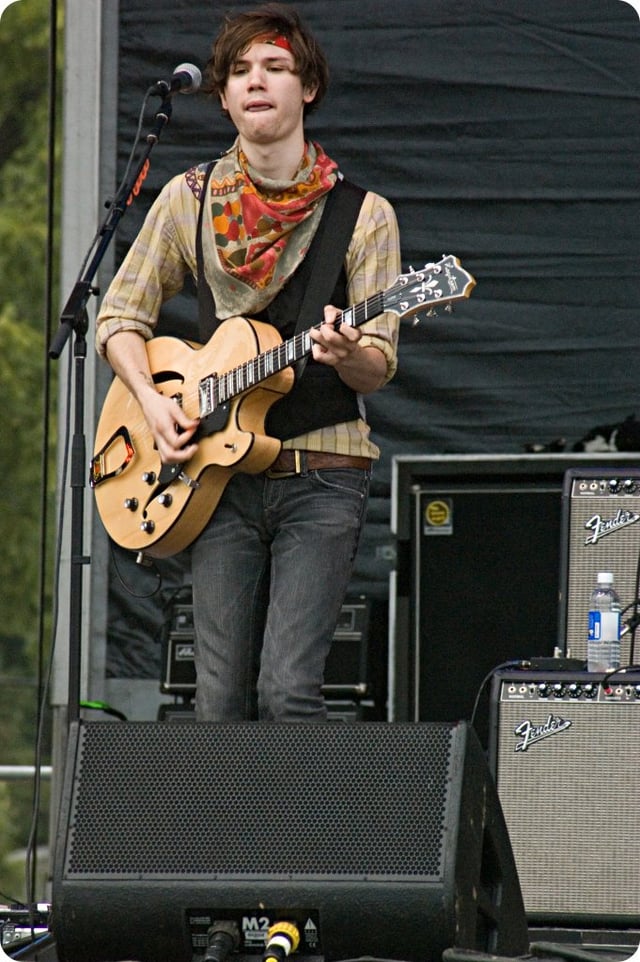 Former guitarist and vocalist Ryan Ross performing with the band in 2007. Ross was responsible for writing most of the music and lyrics until his departure in 2009.