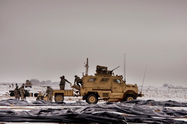 Soldiers from Task Force Currahee, 4th Brigade Combat Team, 101st Airborne Division, recover bundles of fuel January 29, 2011, that were air delivered to Forward Operating Base Waza K'wah, Afghanistan, via a C-17 Globemaster III.