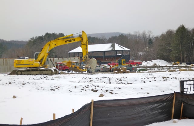 Renovation of Weston Field Athletic Complex - January 2014. The wooden grandstand behind the excavator was built in 1902. It was moved in 1987 to the new Plansky Track and football field and was moved again during the renovations that were completed in September 2014.