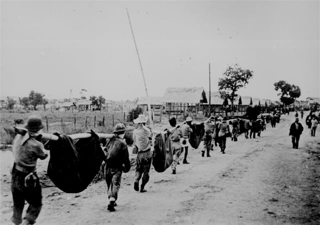 A burial detail of American and Filipino prisoners of war following the Bataan Death March, 1942