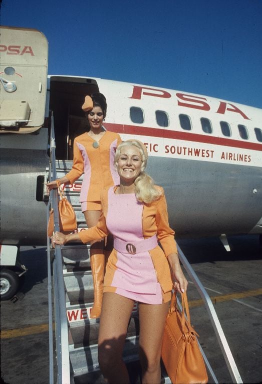 During the 1960s, Pacific Southwest Airlines (PSA) was known for brightly colored female flight attendant uniforms that included short miniskirts. In the early 1970s, the uniform changed to hotpants. Photo shows PSA flight attendants in 1960s.