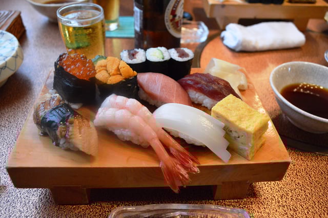 Sushi served on a wooden platter at a sushi restaurant in Kanagawa Prefecture, Japan.