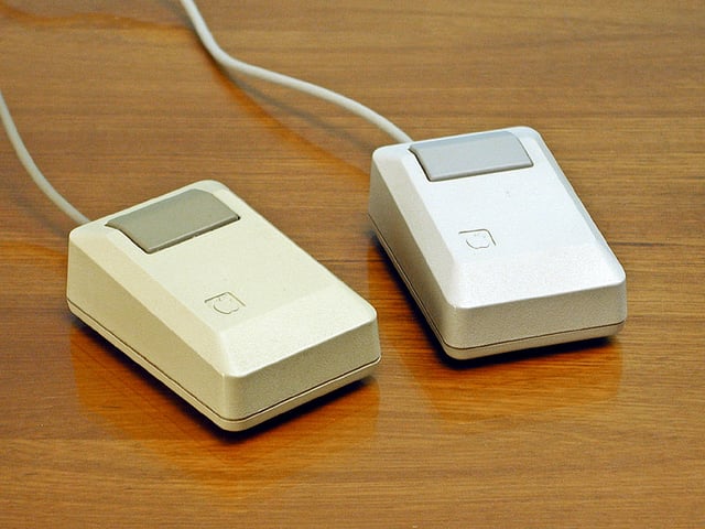 Apple Macintosh Plus mice: beige mouse (left), platinum mouse (right), 1986