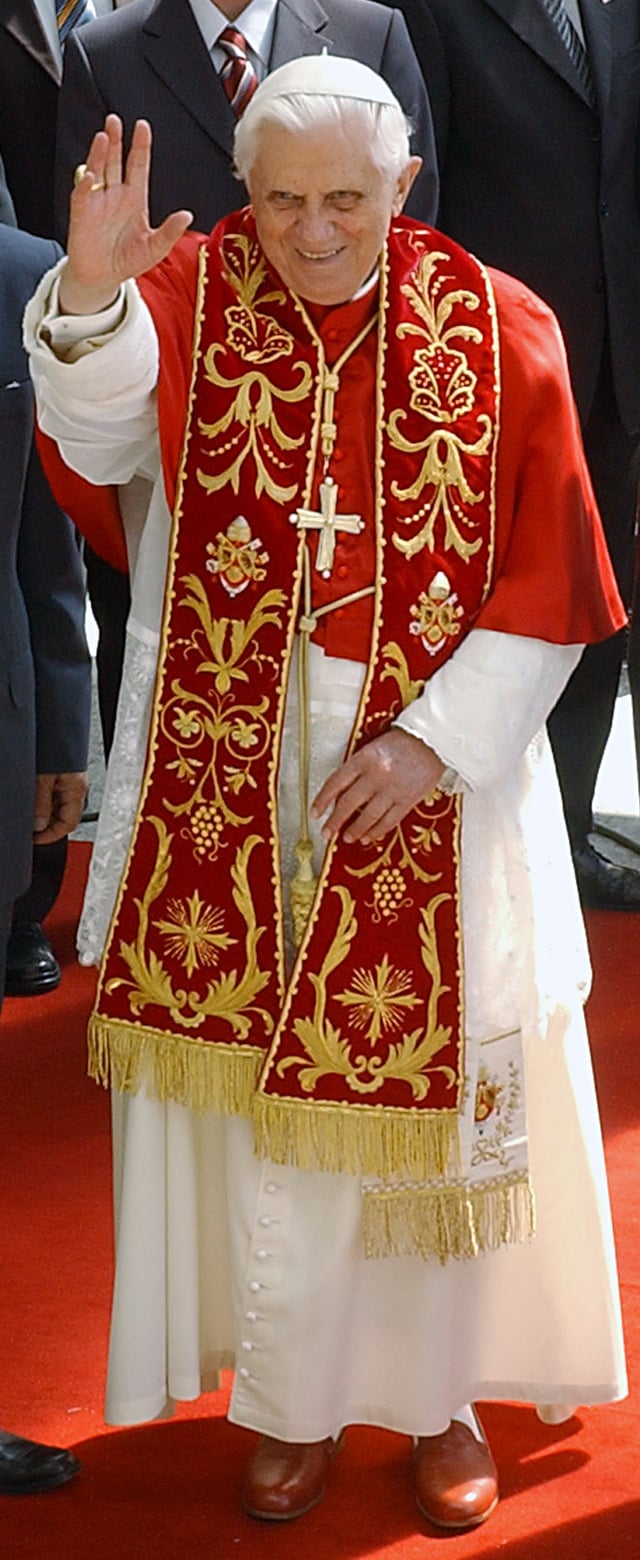 Pope Benedict XVI in choir dress with the red summer papal mozzetta, embroidered red stole, and the red papal shoes