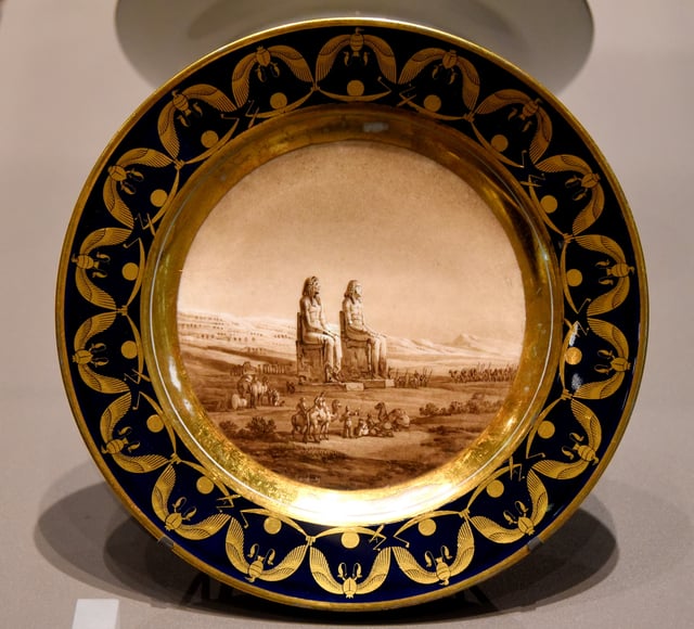 Plate showing statues of Amenhotep III at Luxor, Egypt. Commissioned by Napoleon as a present to Josephine but she rejected it. From France. The Victoria and Albert Museum, London