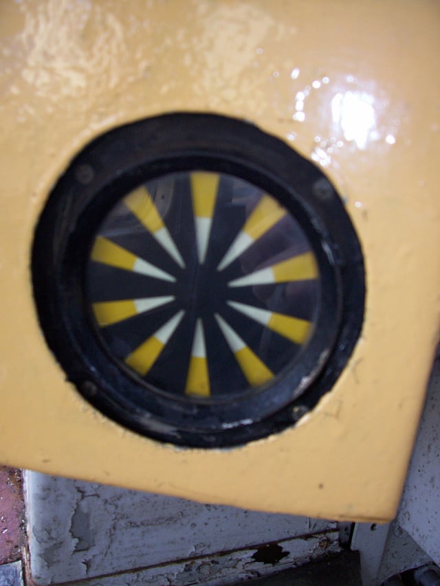 A typical AWS "sunflower" indicator. The indicator shows either a black disk or a yellow and black "exploding" disk.