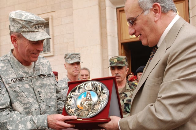 Iraq Defense Minister Abdul Qadir presents a gift to Petraeus during a farewell ceremony in Baghdad on September 15, 2008.