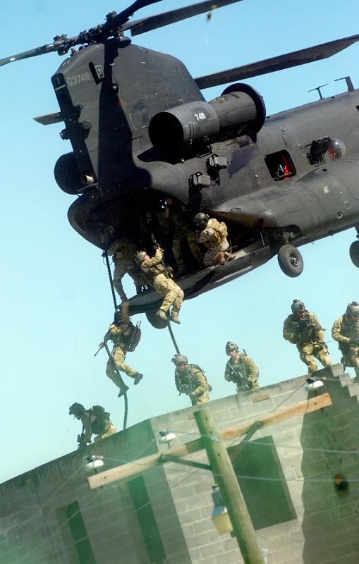 Rangers practice fast roping techniques from an MH-47 during an exercise at Fort Bragg