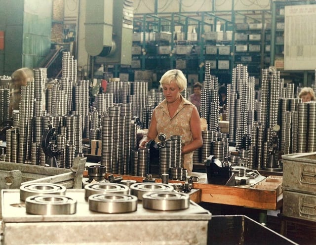 An industrial worker amidst heavy steel components (KINEX BEARINGS, Bytča, Slovakia, c. 1995–2000)