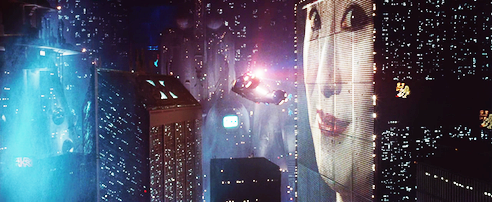 A police spinner flying beside enormous skyscrapers, some with electronic billboards on them. Special effects such as these were benchmarks and have been highly influential on the esthetics of subsequent sci-fi movies.