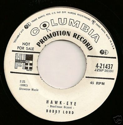 Transitional 1955 promo 45 r.p.m. label showing both the old "notes and mike" and new "walking eye" logos