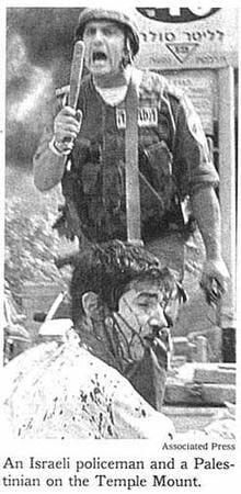 Associated Press photograph misidentified Tuvia Grossman's nationality and the photograph's location, and implied police brutality by Grossman's Israeli rescuer.