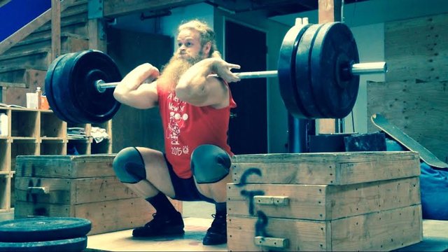 A shot of Alan weightlifting