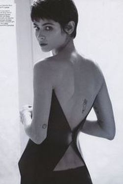 Back shot of Alba Galocha; the images show four of her tattoos.