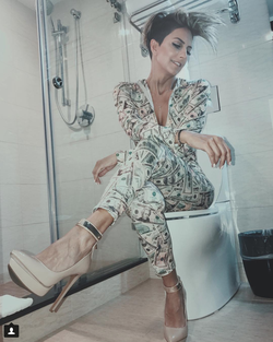Photo of Alineh Avanessian wearing a stylish women's suit with money pattern.