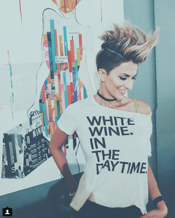 Photo of Alineh Avanessian standing beside a painting.