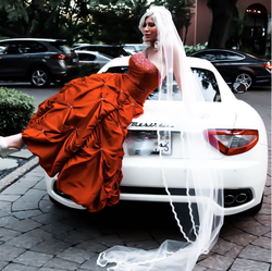 Photo of Ariane Bellamar posing for a photo on top of her Maserati.