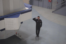 Christopher Altman salutes before ingress conducting High G Centrifuge training.