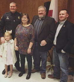 Photo of police officer Brandon Hicks taken with other people, presumably his family members