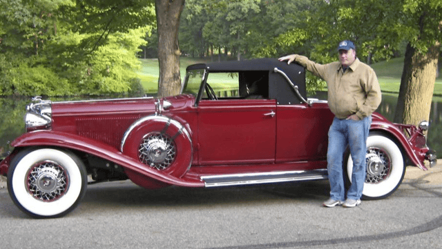 Photo of Brent with one of his favorite antique cars.