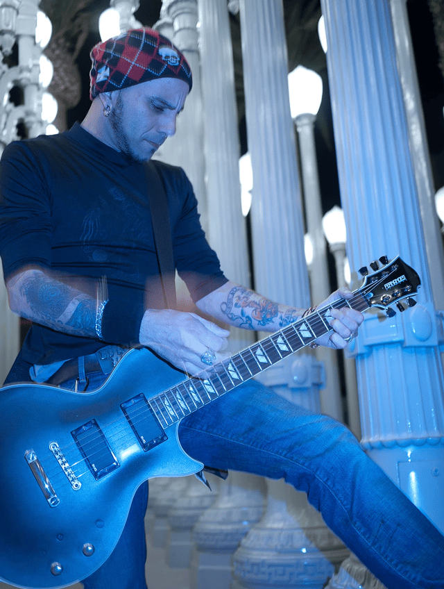 Photo of Carlos where he plays his electric guitar at the LACMA urban lights.