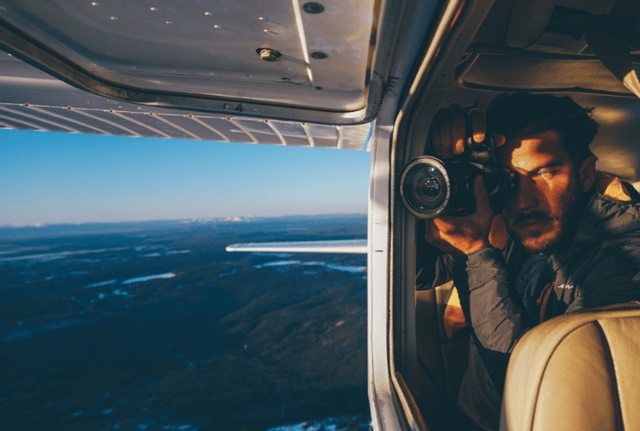 Cory Tran taking a photo from a plane