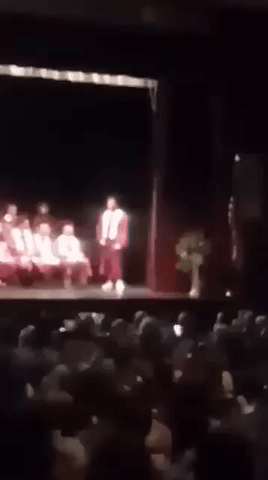 Dallas graduating from high school.