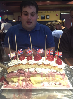 Photo of Daniel Frisiello blowing out candles.