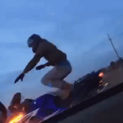 Danny Hamilton standing on a motorcycle