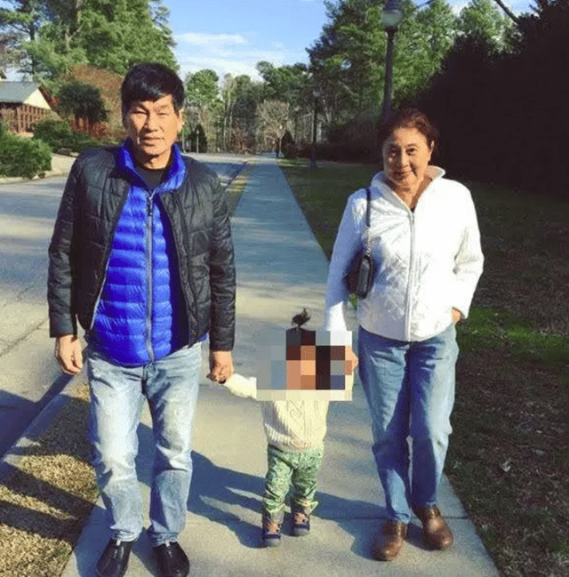 Photo of David taking a stroll with his granddaughter and wife.