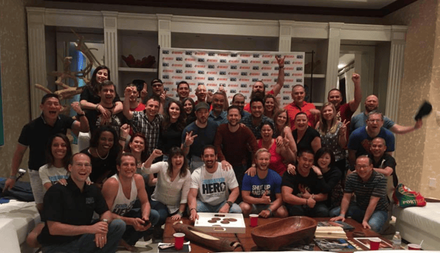 Photo of Dave with his large team.