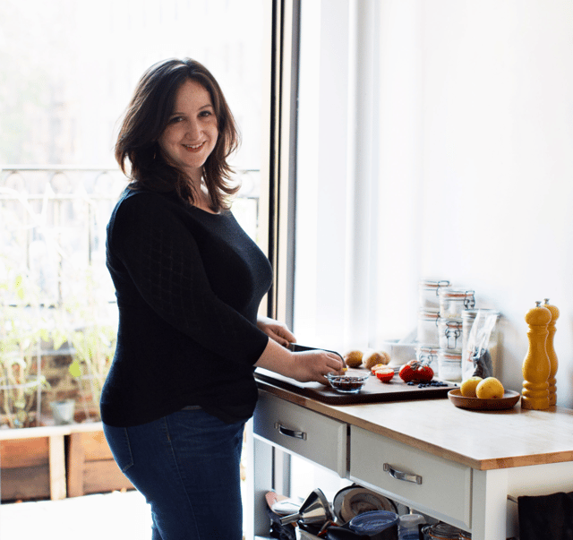 Photo of Deb in her tiny kitchen.