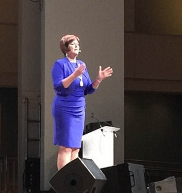 Debbie at a live event giving a talk.