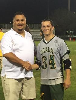 Photo of Deputy James Long with a student athlete from the high school where he works.