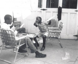 Photo from December 1964, of Donald Osborne (age 9) celebrating after finishing a Lotus 29 model car with his older brother, Art Osborne.