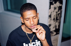 Photo of Ezri Walker holding up his gold chain.