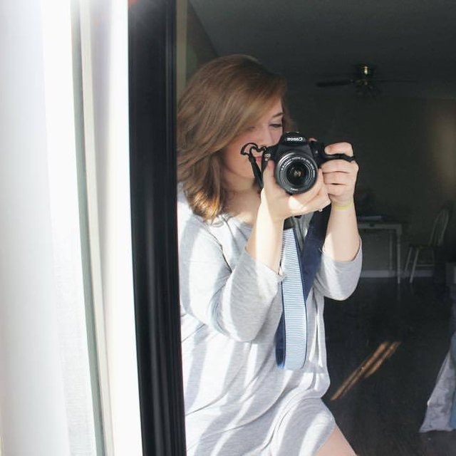 Hannah taking a photo with her camera
