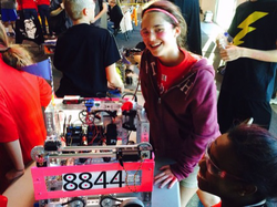 Herbst smiling with the FTC 8844 robot at the FIRST Tech Challenge