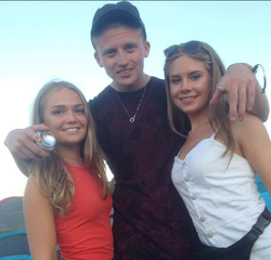 Photo of Jack Ryan Smith with two girls.