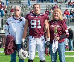 Jason Seaman in his Southern Illinois Salukis Football Team uniform with his parents