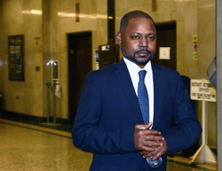 Photo of Jelani Mara j walking out of court.