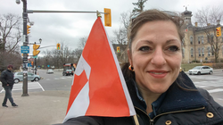 Photo of Jennifer Bush with a Canadian flag