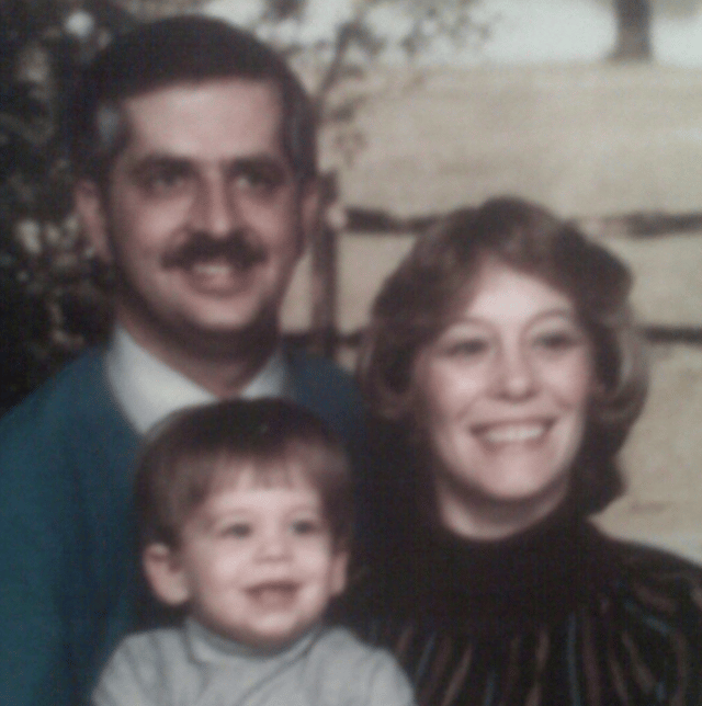 Photo of John with his parents when he was a little boy.