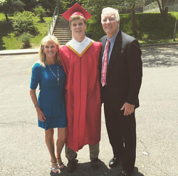 Photo of John Rigsby with his parents on his high school graduation day.