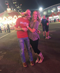 Photo of Kami Gilstrap with her husband Blake Gilstrap at a fair.