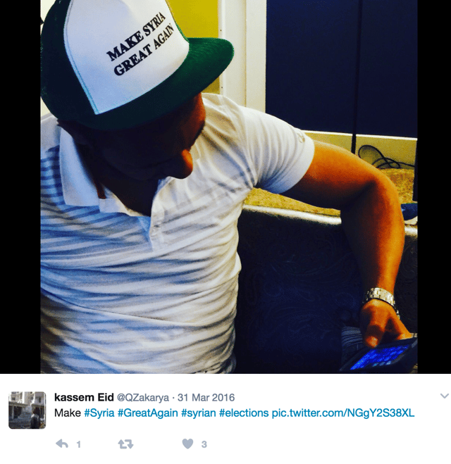 Kassem wears a hat that says, "Make Syria Great Again".