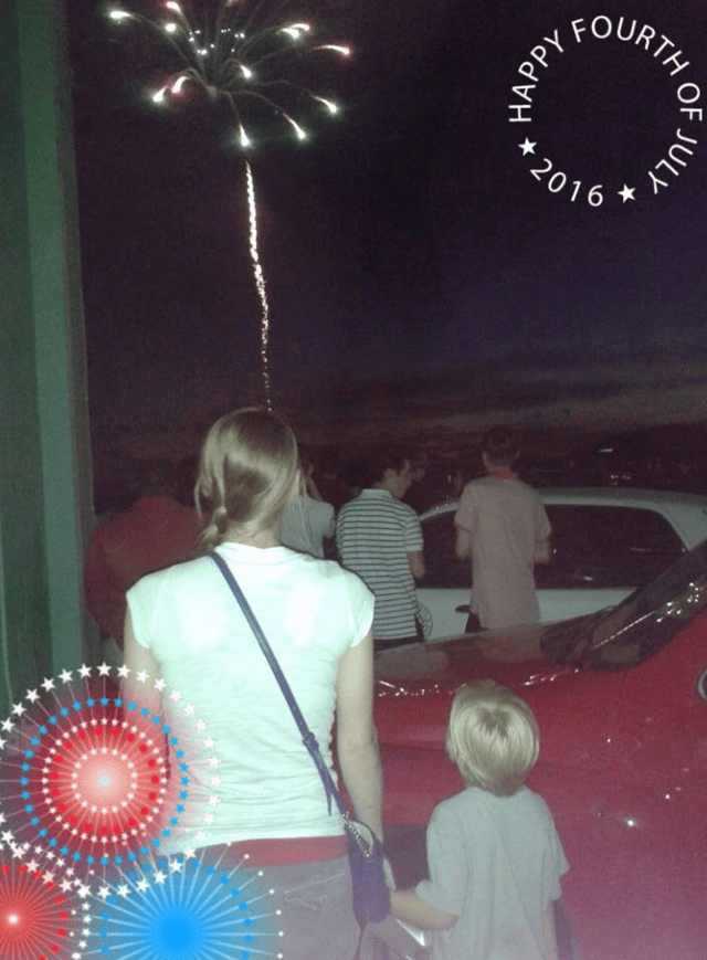 Kayla with her child watching the 4th of July fireworks.