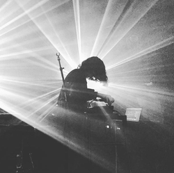 Black and white photo of Kelly Lee Owens during a live set.