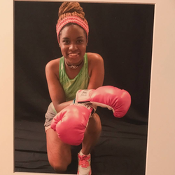 Photo of Kenidra Woods with Boxing gloves.