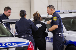 Photo of Lola Jean Amorin being arrested in 2017